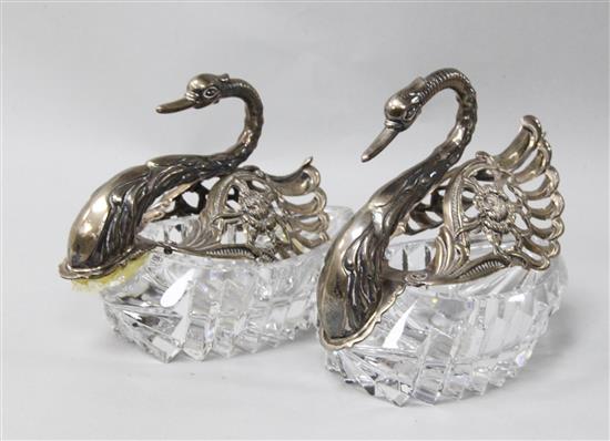 A pair of 1980s repousse silver mounted cut glass sweetmeat dishes modelled as swans, height 4in.